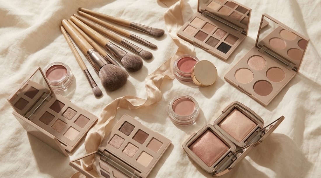 Professional makeup kit arranged on ivory linen